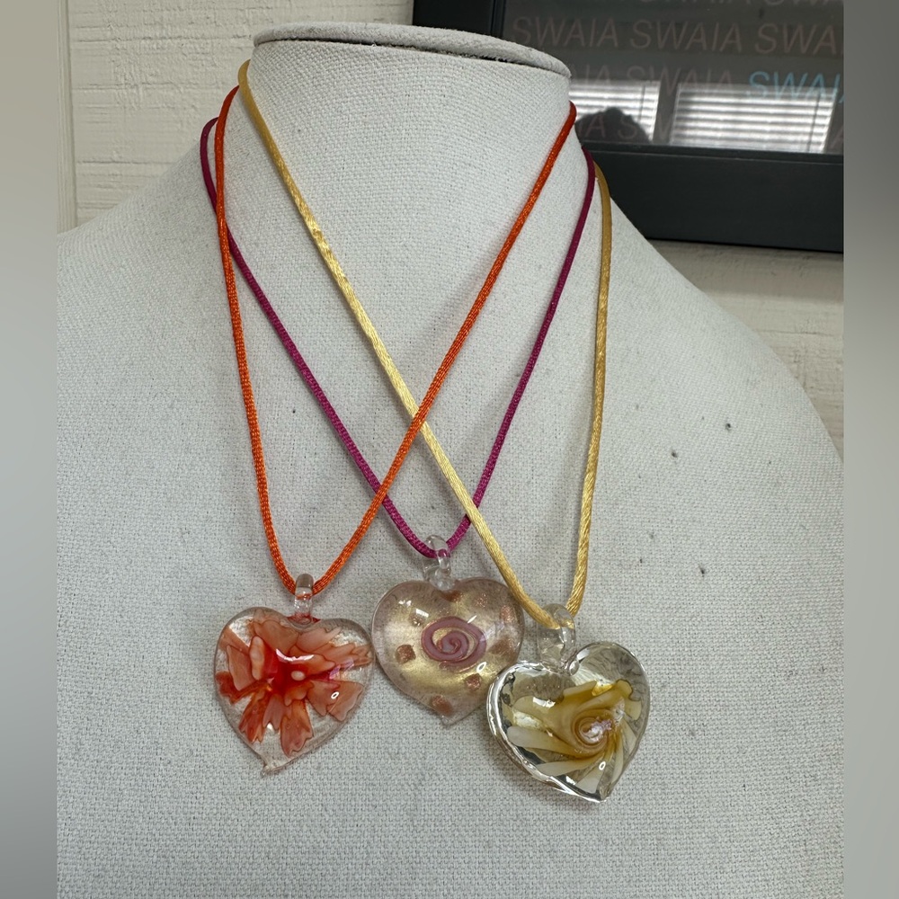 Three glass heart necklaces on satin cord